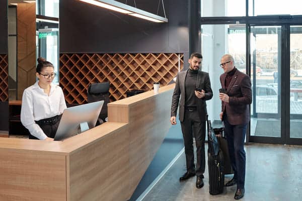 businessmen discussing data in smartphone
